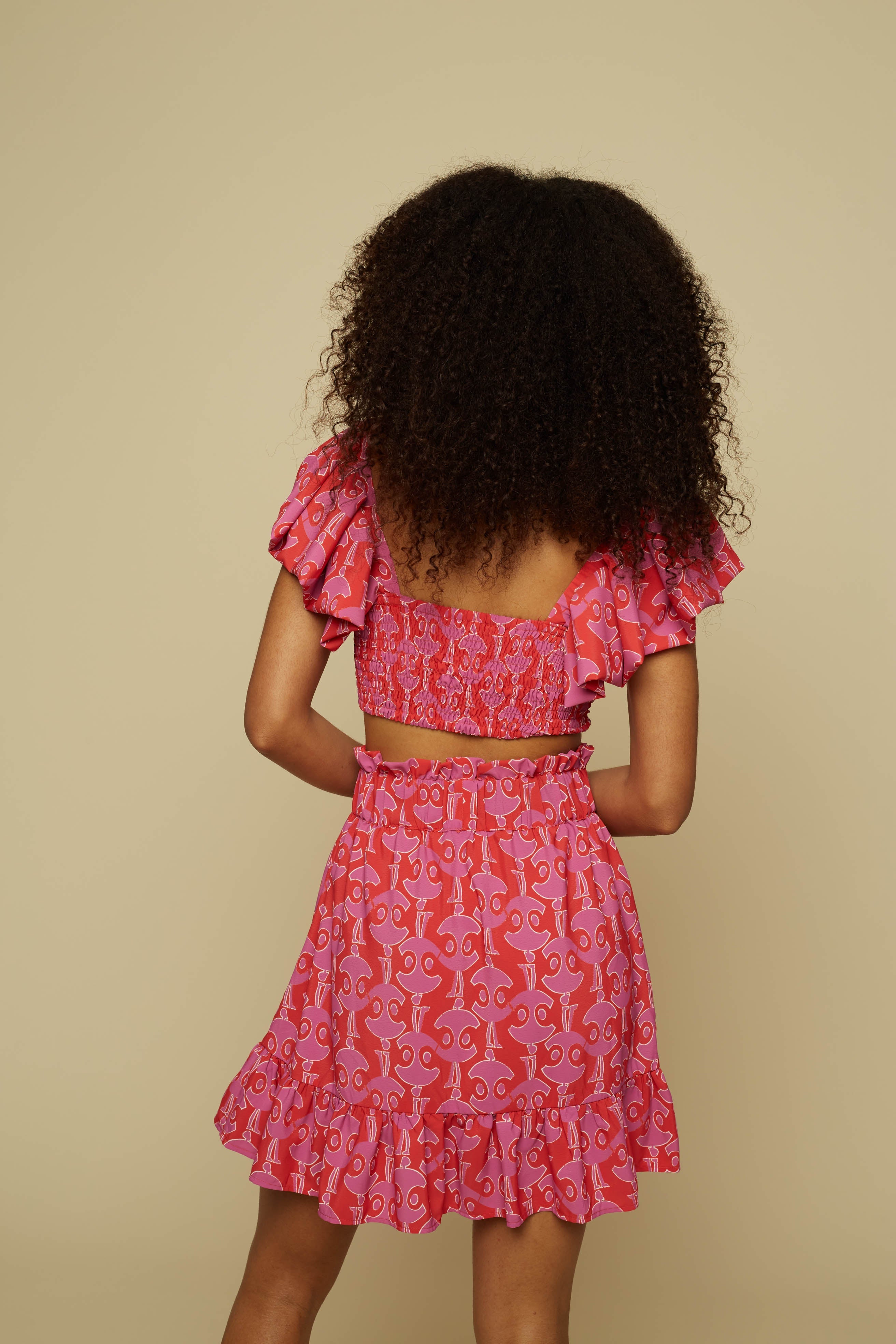 TECTON CROP TOP (PINK GEO PEOPLE PRINT)